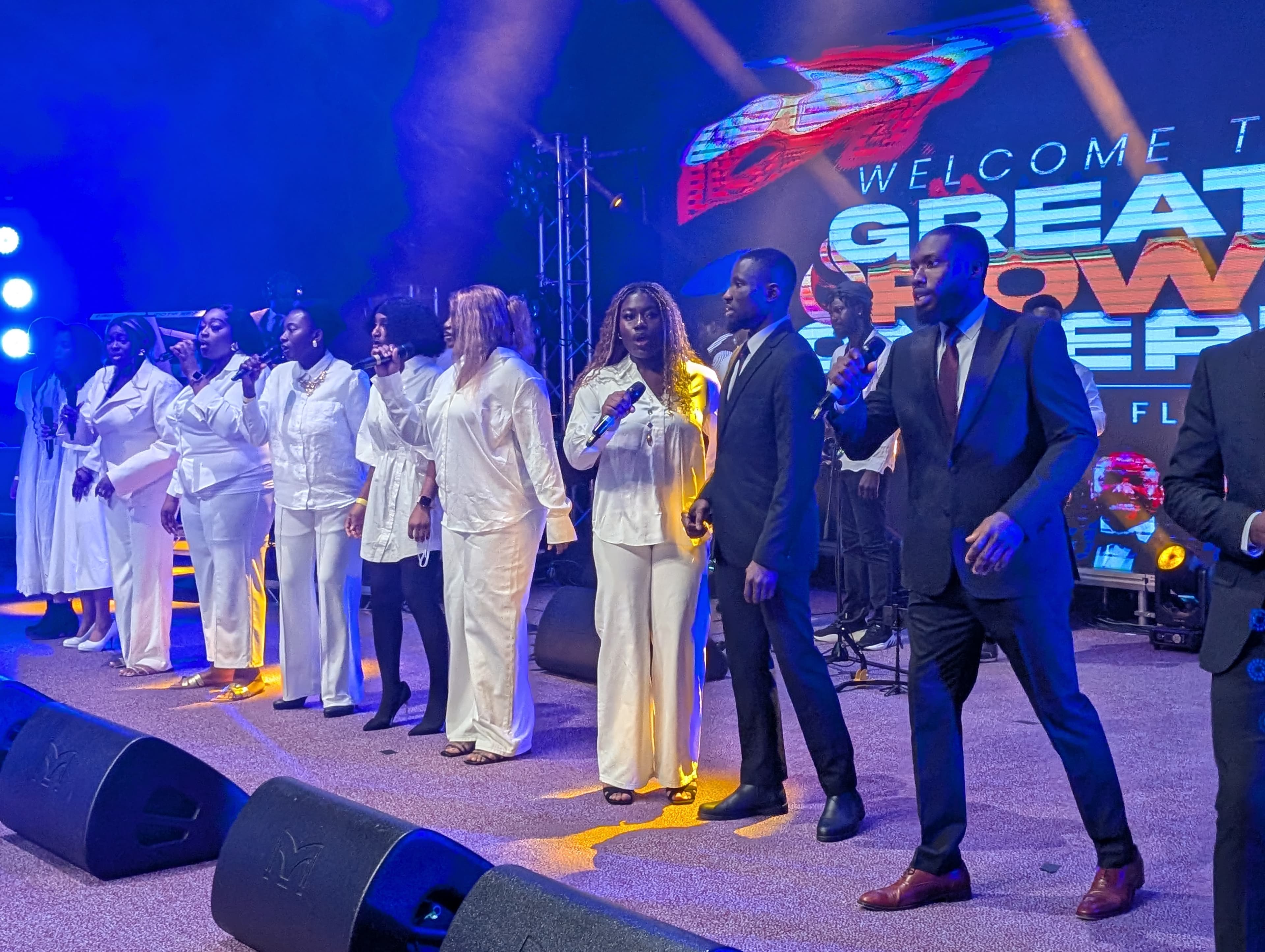 A choir in white leading worship at the Greater Power Conference